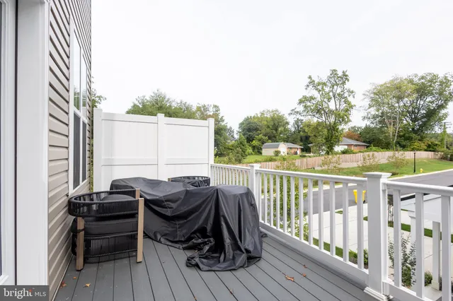 a view of balcony with wooden floor and seating space