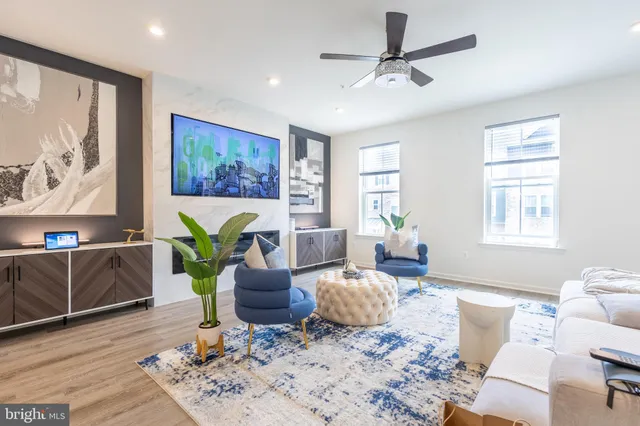 a living room with furniture a window and a potted plant
