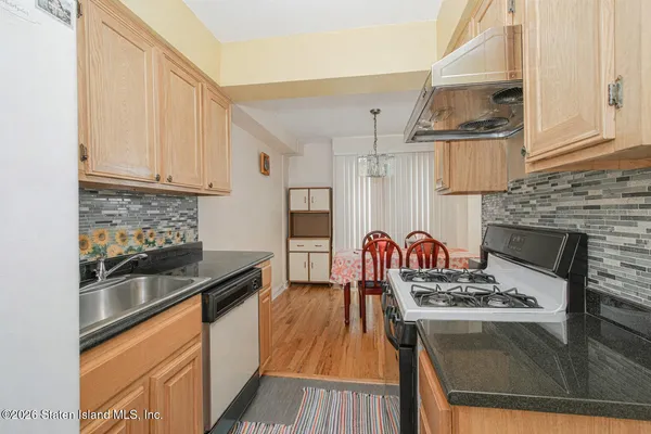 a kitchen with kitchen island granite countertop a stove and a sink