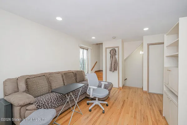 a living room with furniture and a wooden floor