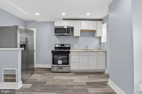 a kitchen with stainless steel appliances a refrigerator stove and microwave