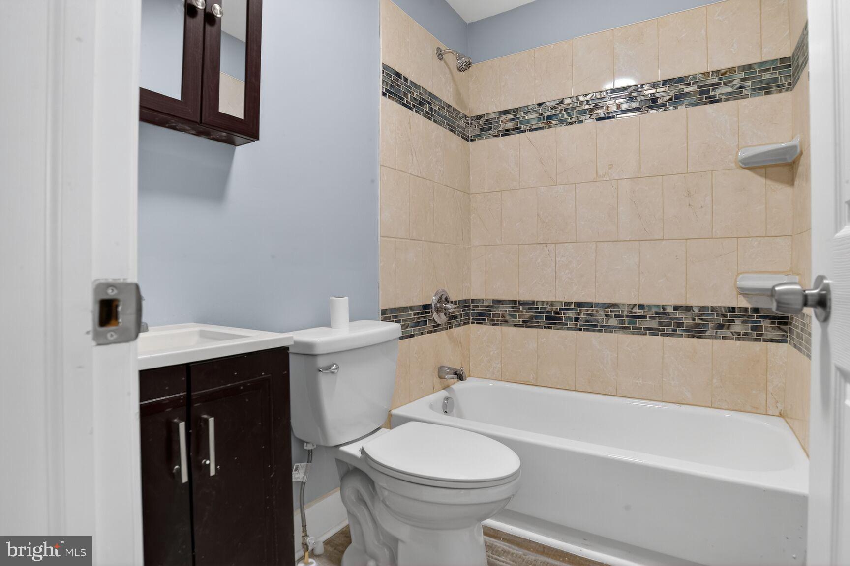 3335 Lyndale Avenue Baltimore, MD 21213 - Photo 3 of 9 a bathroom with a sink a toilet and shower