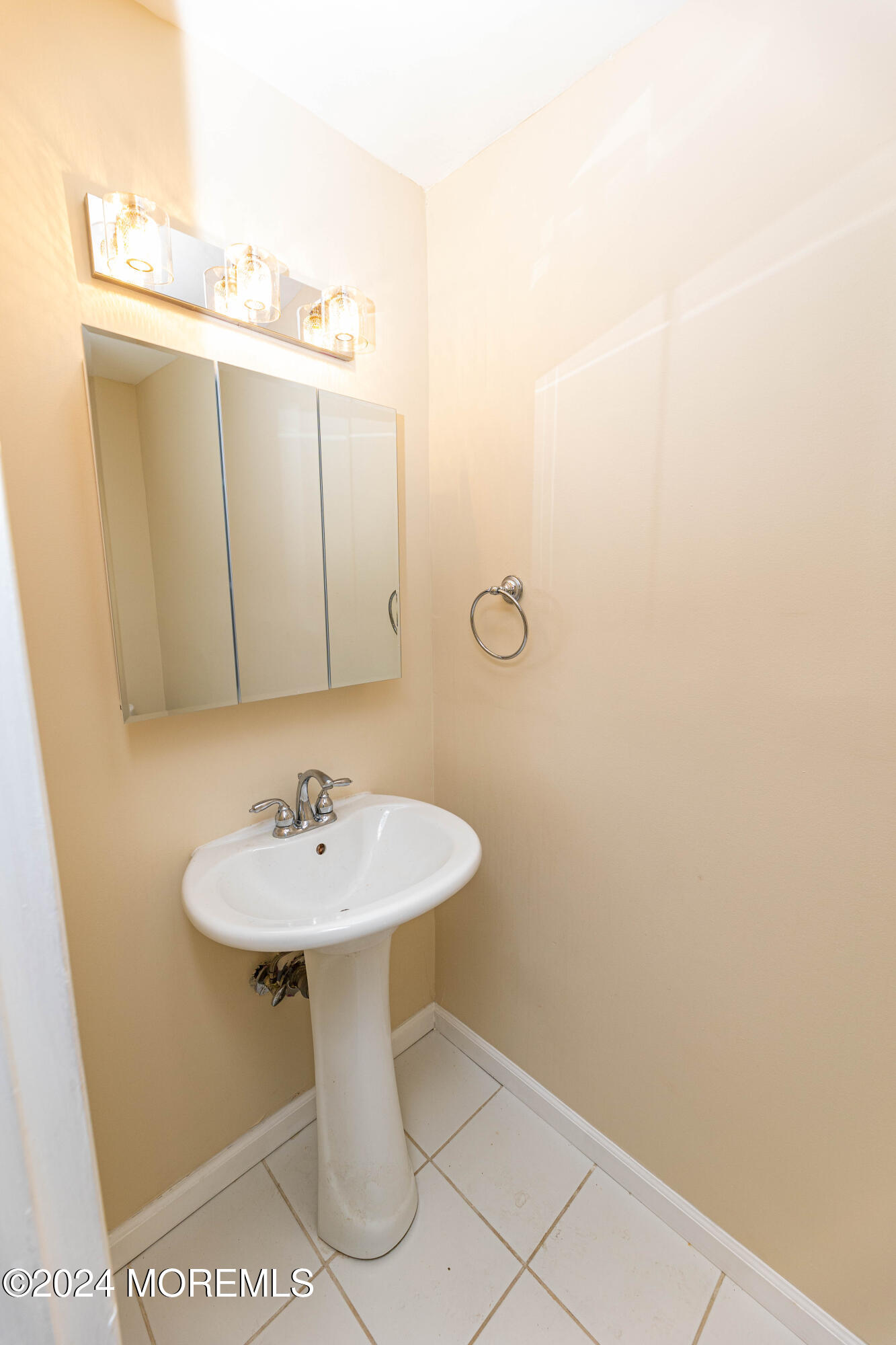 301 Spring Street, Unit 11 Red Bank, NJ 07701 - Photo 23 of 40 a bathroom with a sink a mirror and vanity