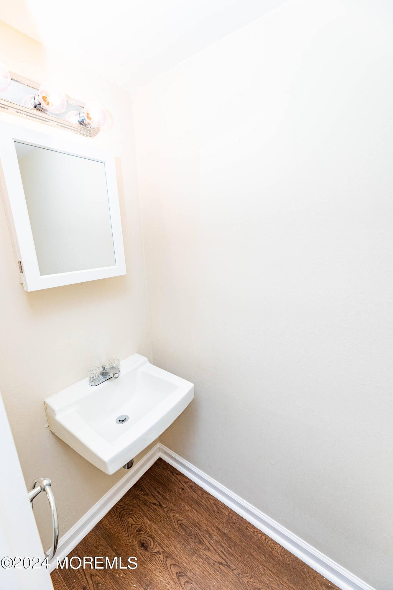 301 Spring Street, Unit 11 Red Bank, NJ 07701 - Photo 24 of 40 a white bathroom with a sink and a mirror