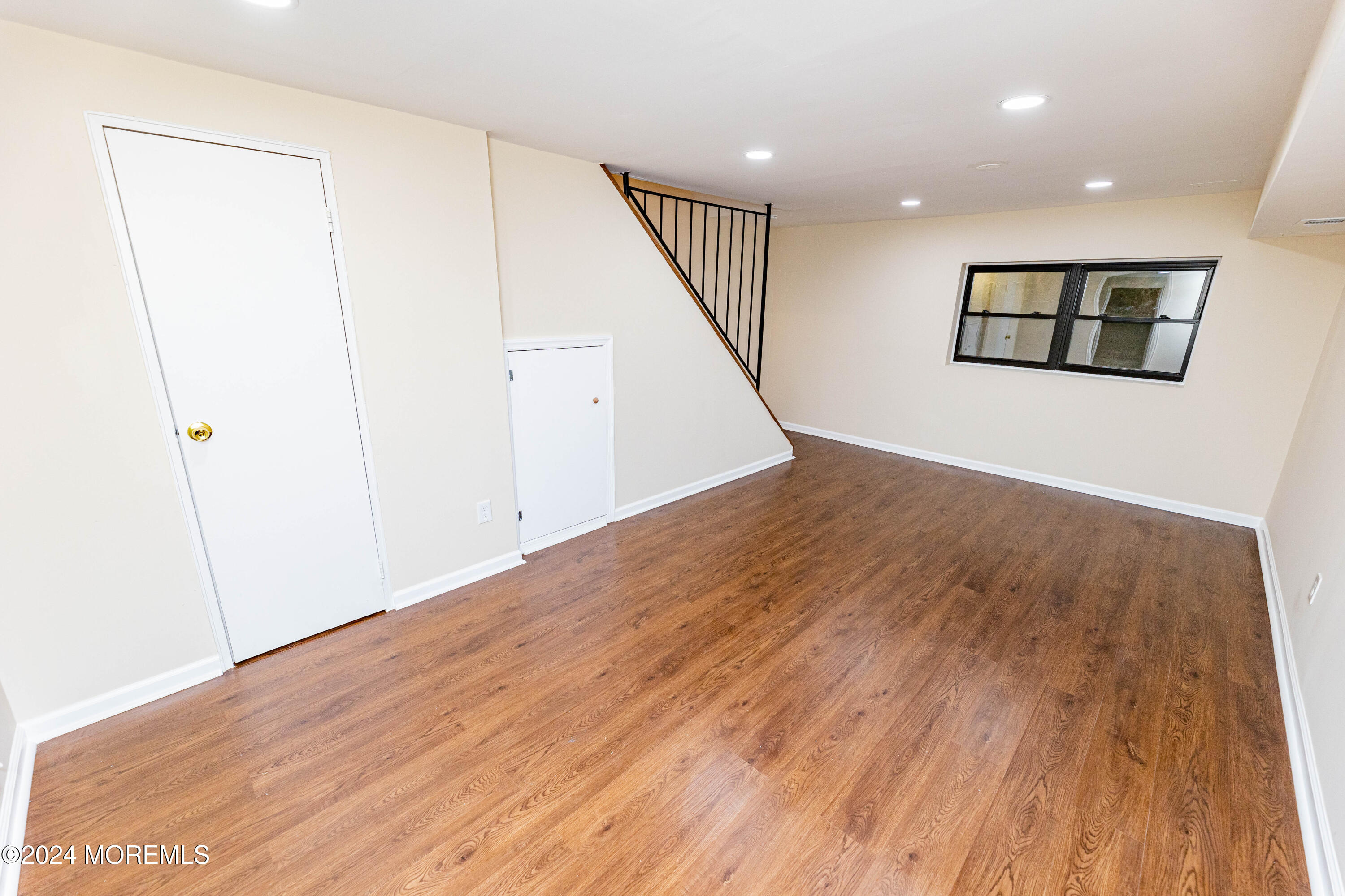 301 Spring Street, Unit 11 Red Bank, NJ 07701 - Photo 26 of 40 an empty room with wooden floor and hallway