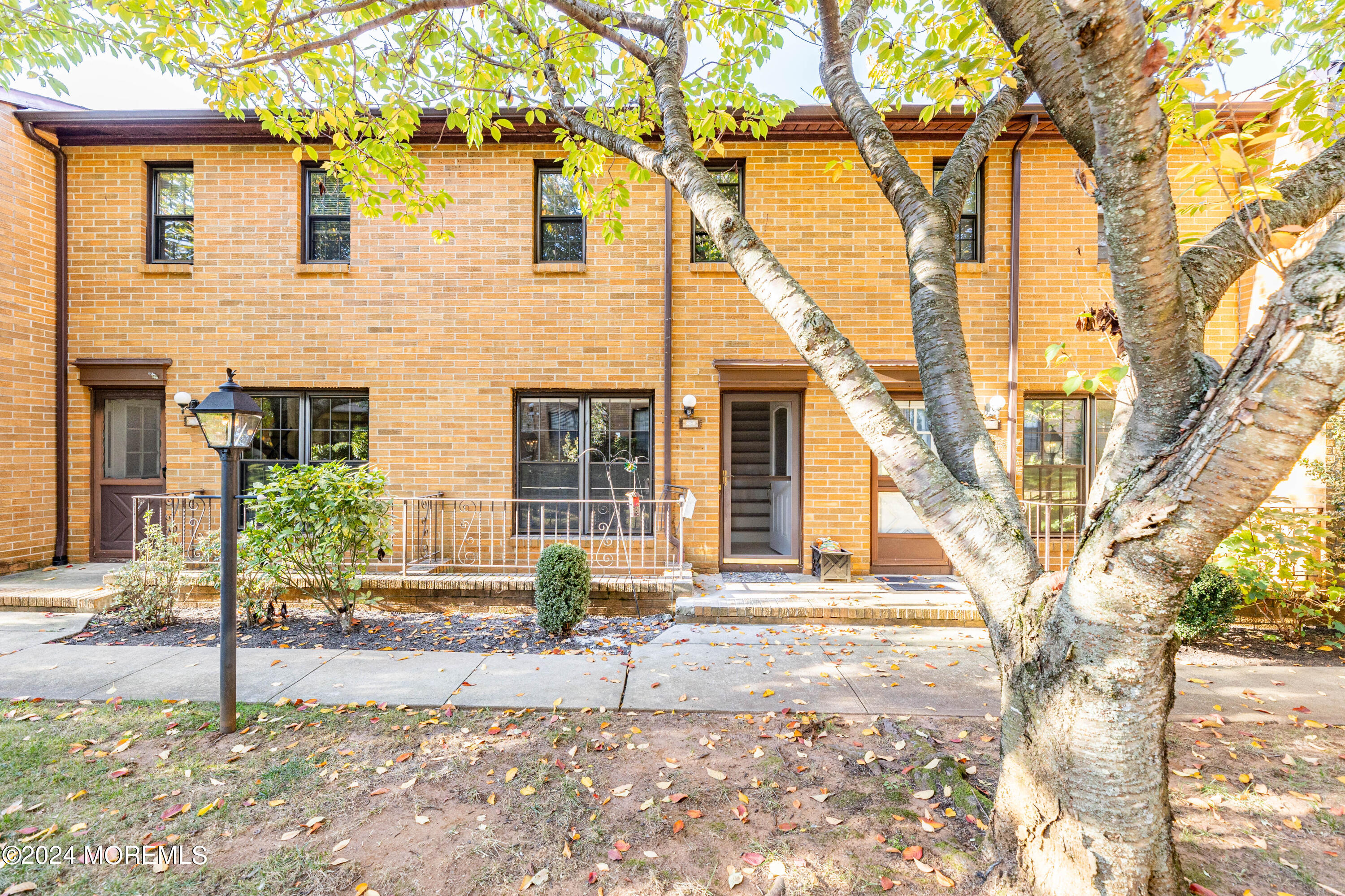 301 Spring Street, Unit 11 Red Bank, NJ 07701 - Photo 3 of 40 a front view of a house with a tree in front
