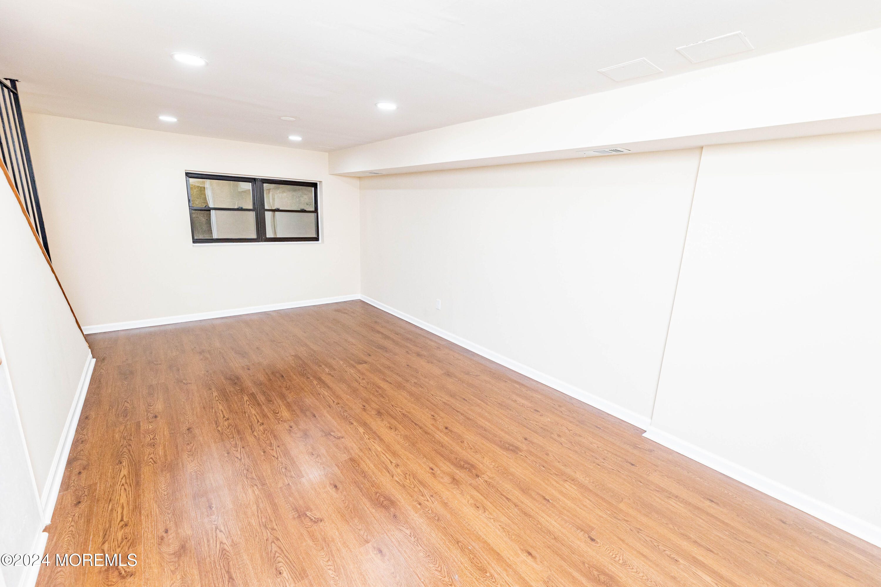 301 Spring Street, Unit 11 Red Bank, NJ 07701 - Photo 31 of 40 a view of a big room with wooden floor and a window
