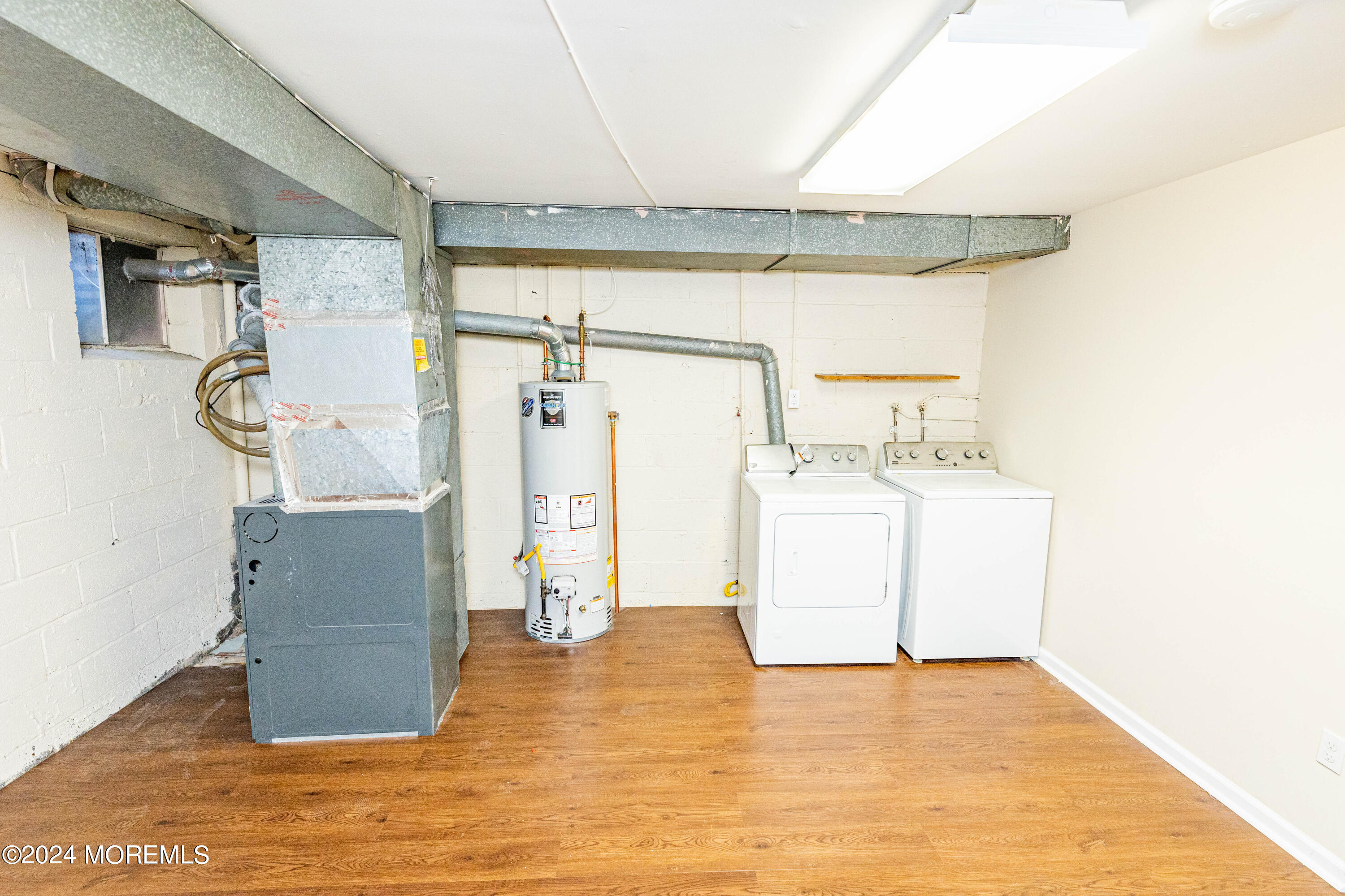 301 Spring Street, Unit 11 Red Bank, NJ 07701 - Photo 33 of 40 a view of a room with wooden floor washer and dryer
