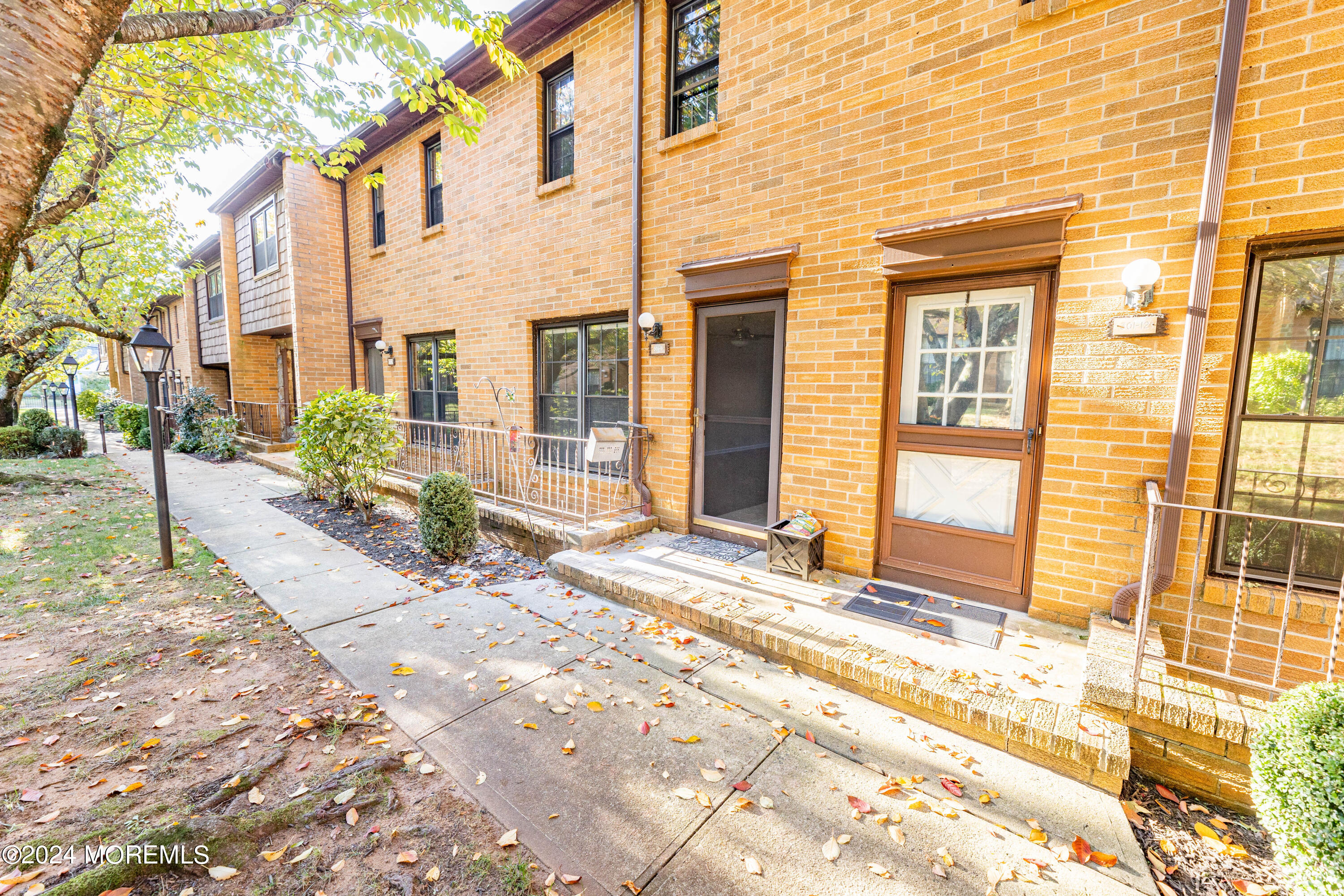 301 Spring Street, Unit 11 Red Bank, NJ 07701 - Photo 36 of 40 a view of a brick house with many windows next to a road