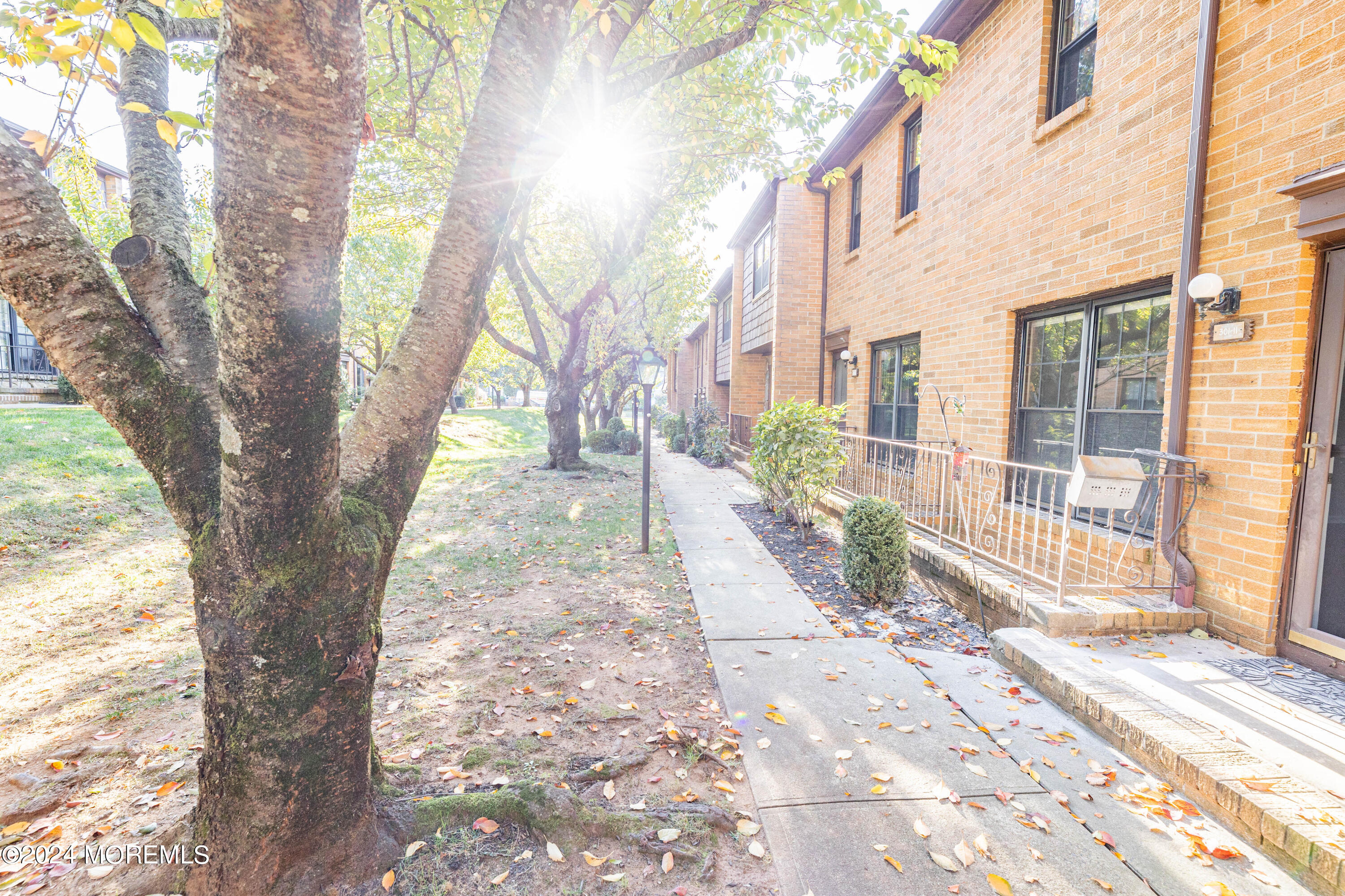 301 Spring Street, Unit 11 Red Bank, NJ 07701 - Photo 37 of 40 a view of a pathway with a yard in the house