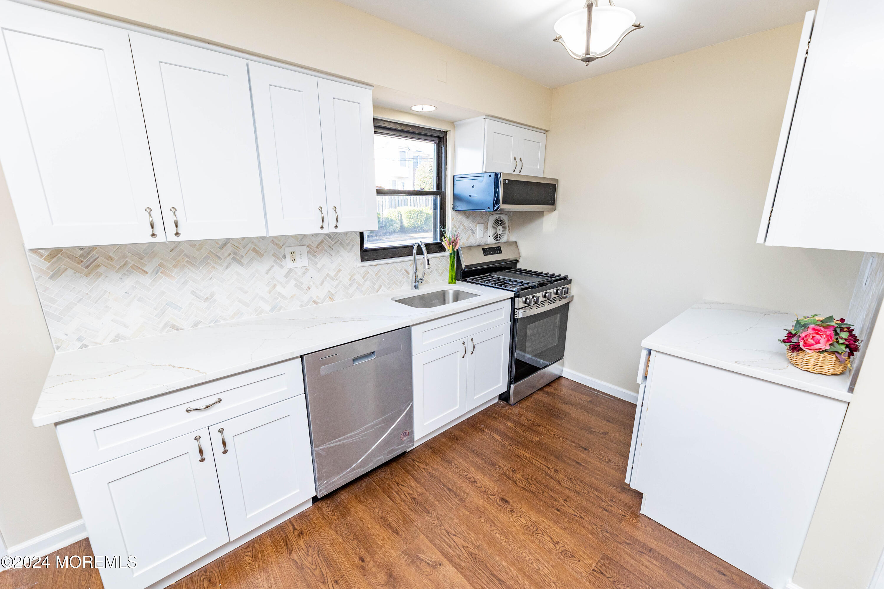 301 Spring Street, Unit 11 Red Bank, NJ 07701 - Photo 4 of 40 a kitchen with a white cabinets and white appliances