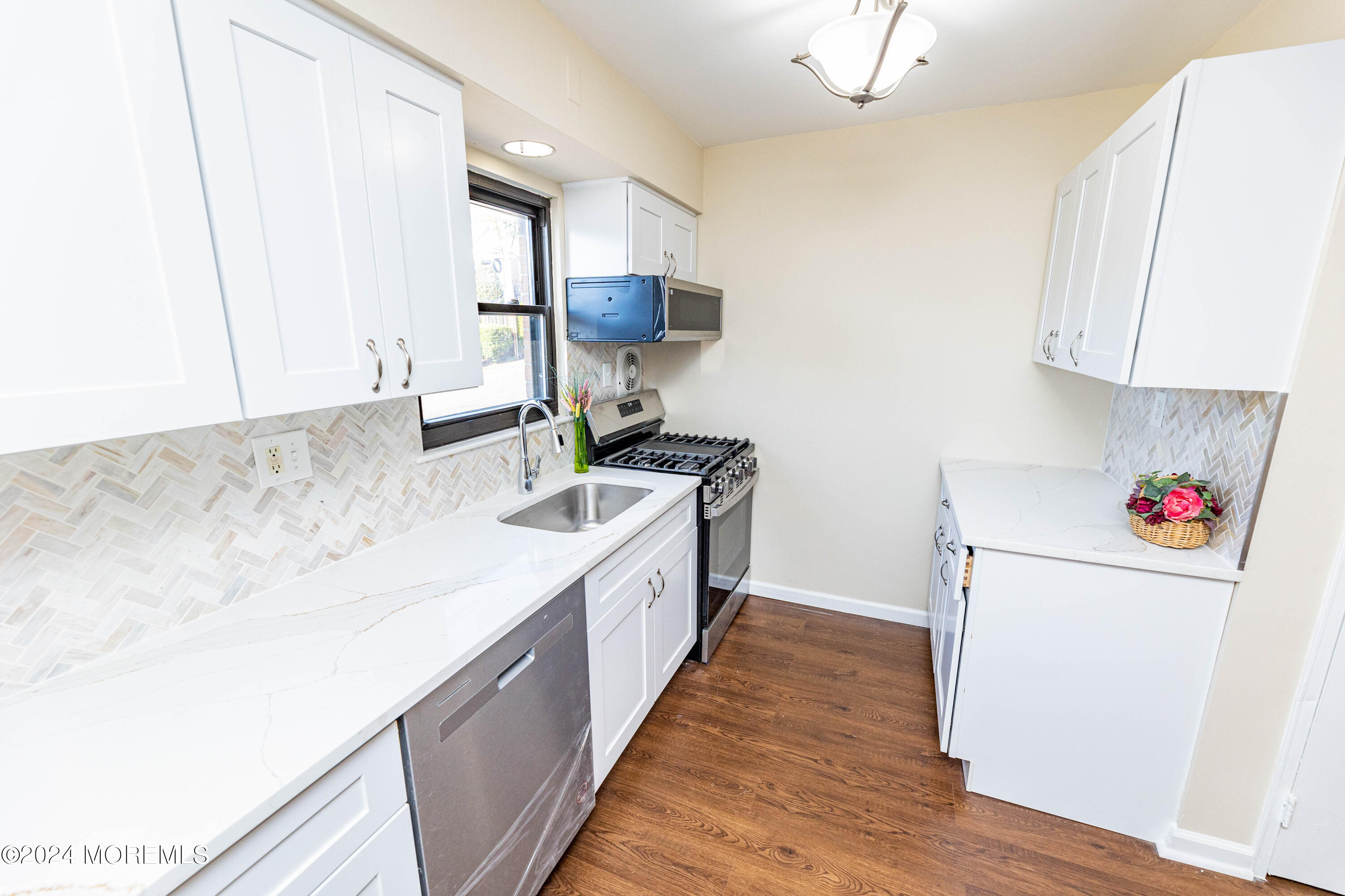 301 Spring Street, Unit 11 Red Bank, NJ 07701 - Photo 7 of 40 a kitchen with a sink cabinets and wooden floor