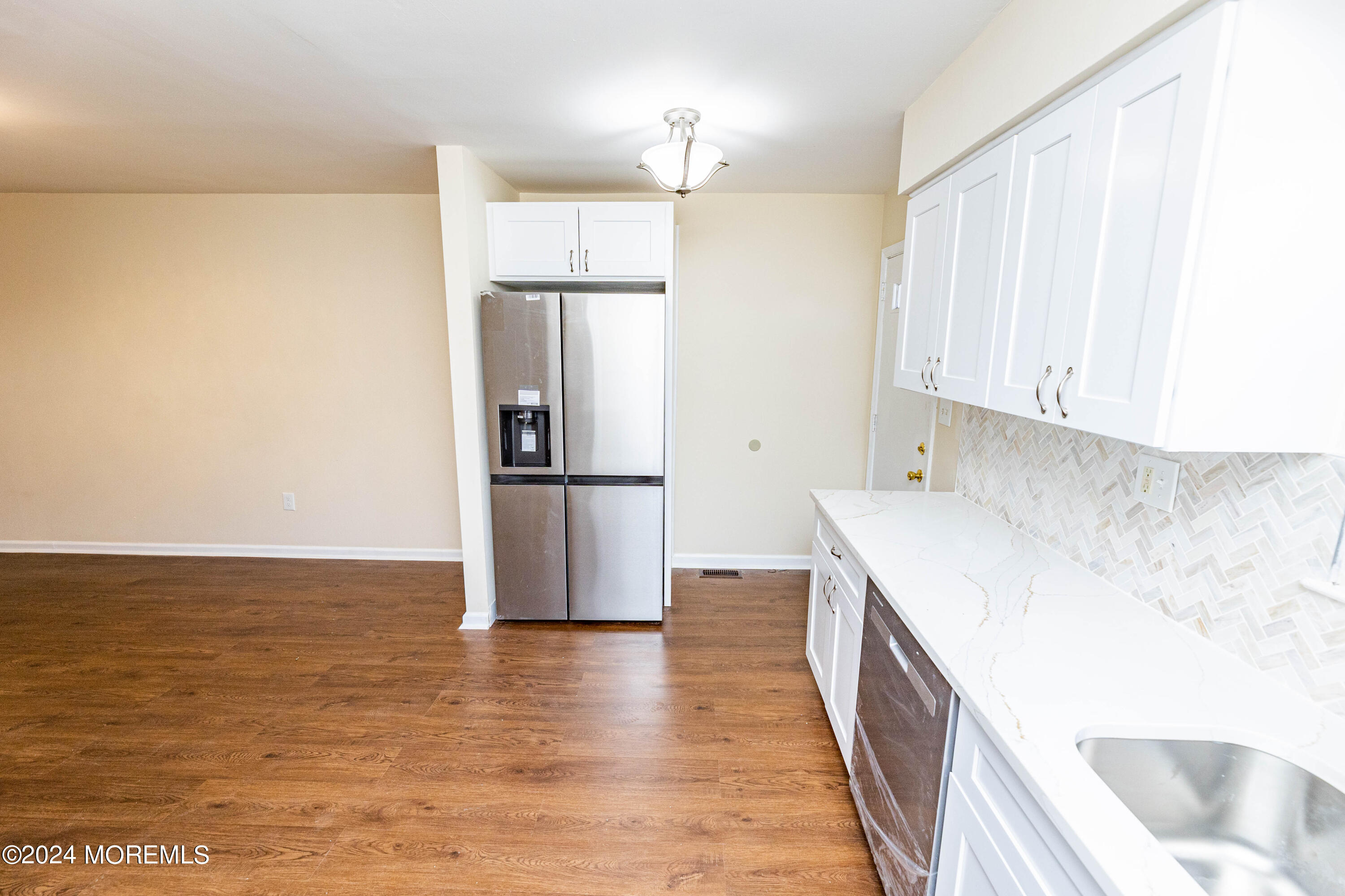 301 Spring Street, Unit 11 Red Bank, NJ 07701 - Photo 9 of 40 a kitchen with a sink a refrigerator and wooden floor