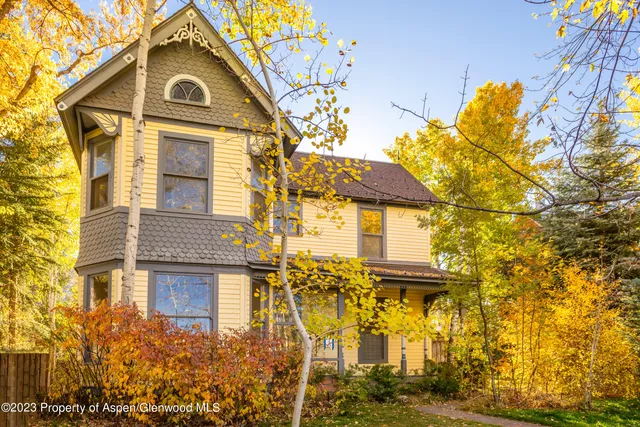 a view of a brick house with large windows