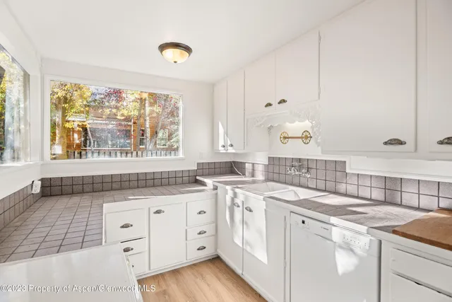a kitchen with a sink cabinets and window