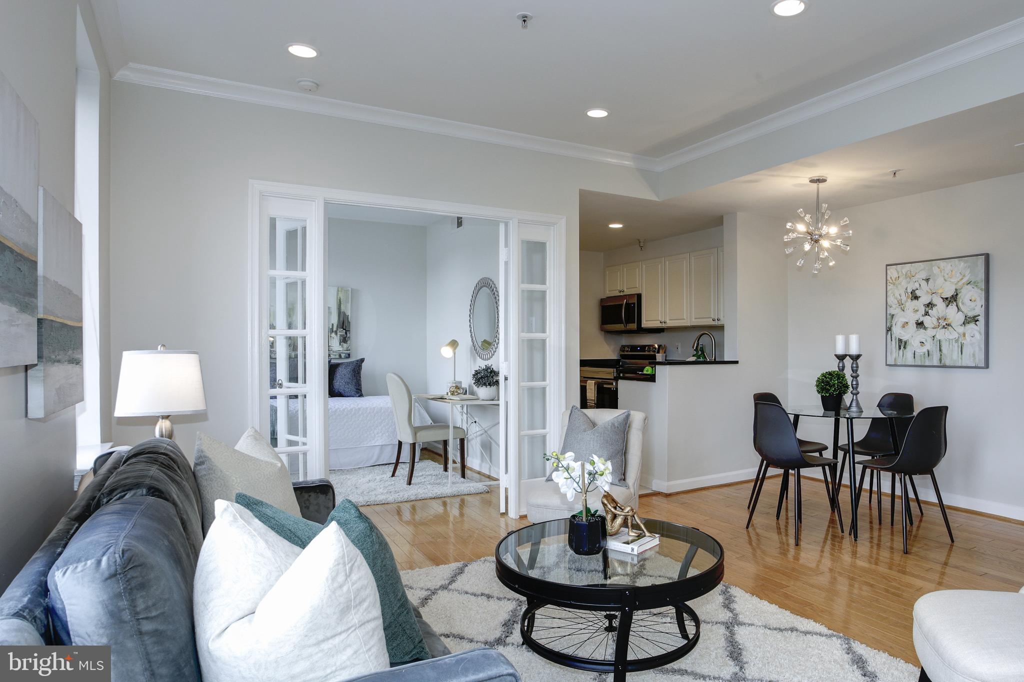 a living room with furniture kitchen view and a table