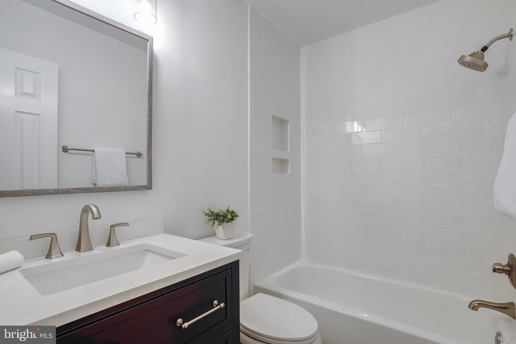 1619 R Street Northwest, Unit 404 Washington, DC 20009 - Photo 14 of 24 a bathroom with a sink and a mirror