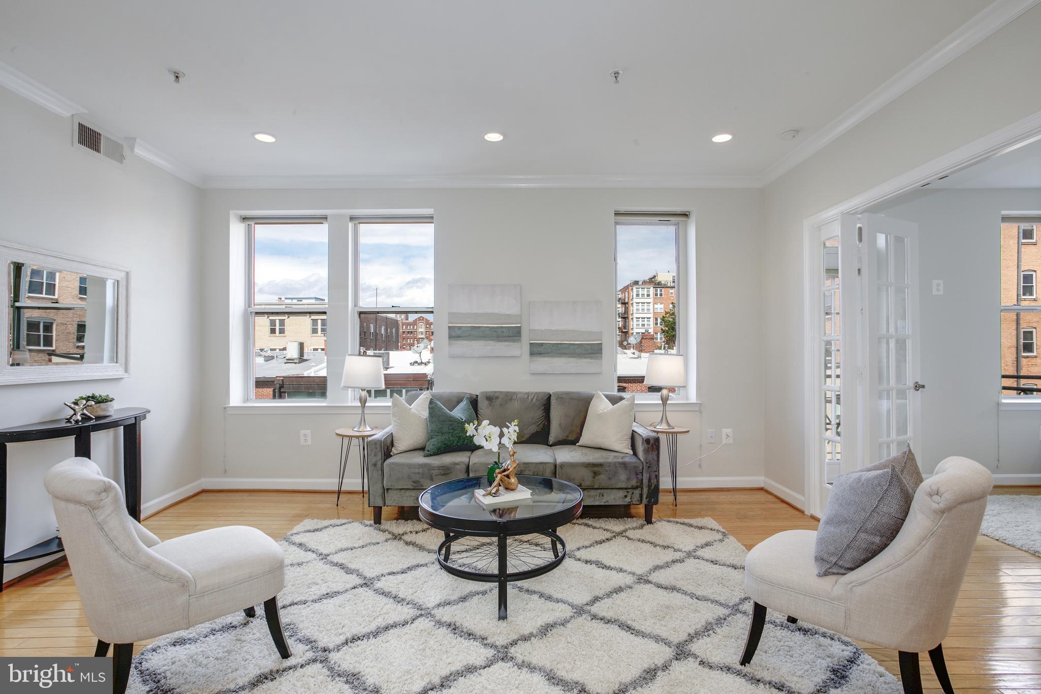 1619 R Street Northwest, Unit 404 Washington, DC 20009 - Photo 2 of 24 a living room with furniture and windows