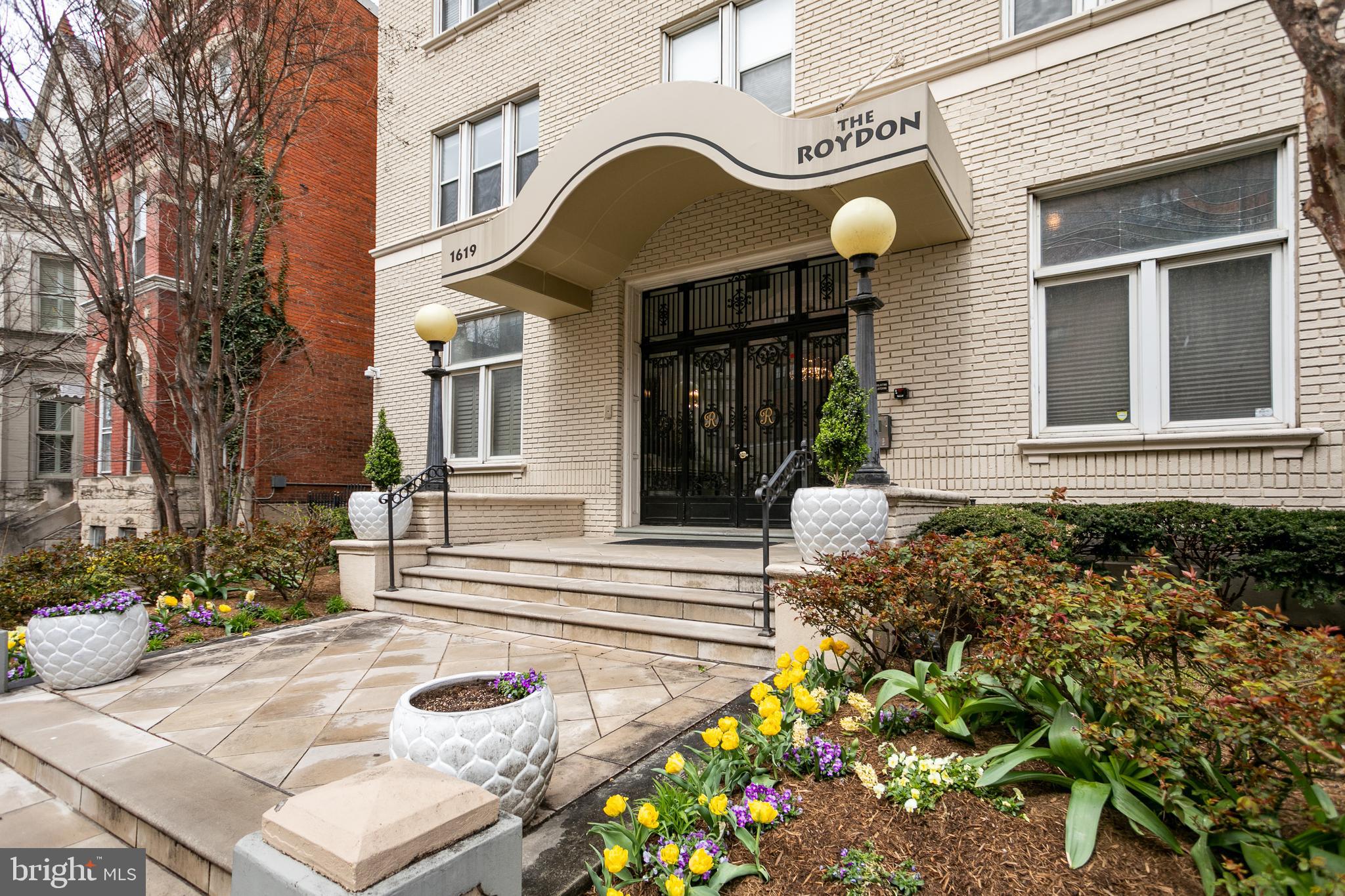 1619 R Street Northwest, Unit 404 Washington, DC 20009 - Photo 23 of 24 a view of a house with large windows and flower plants