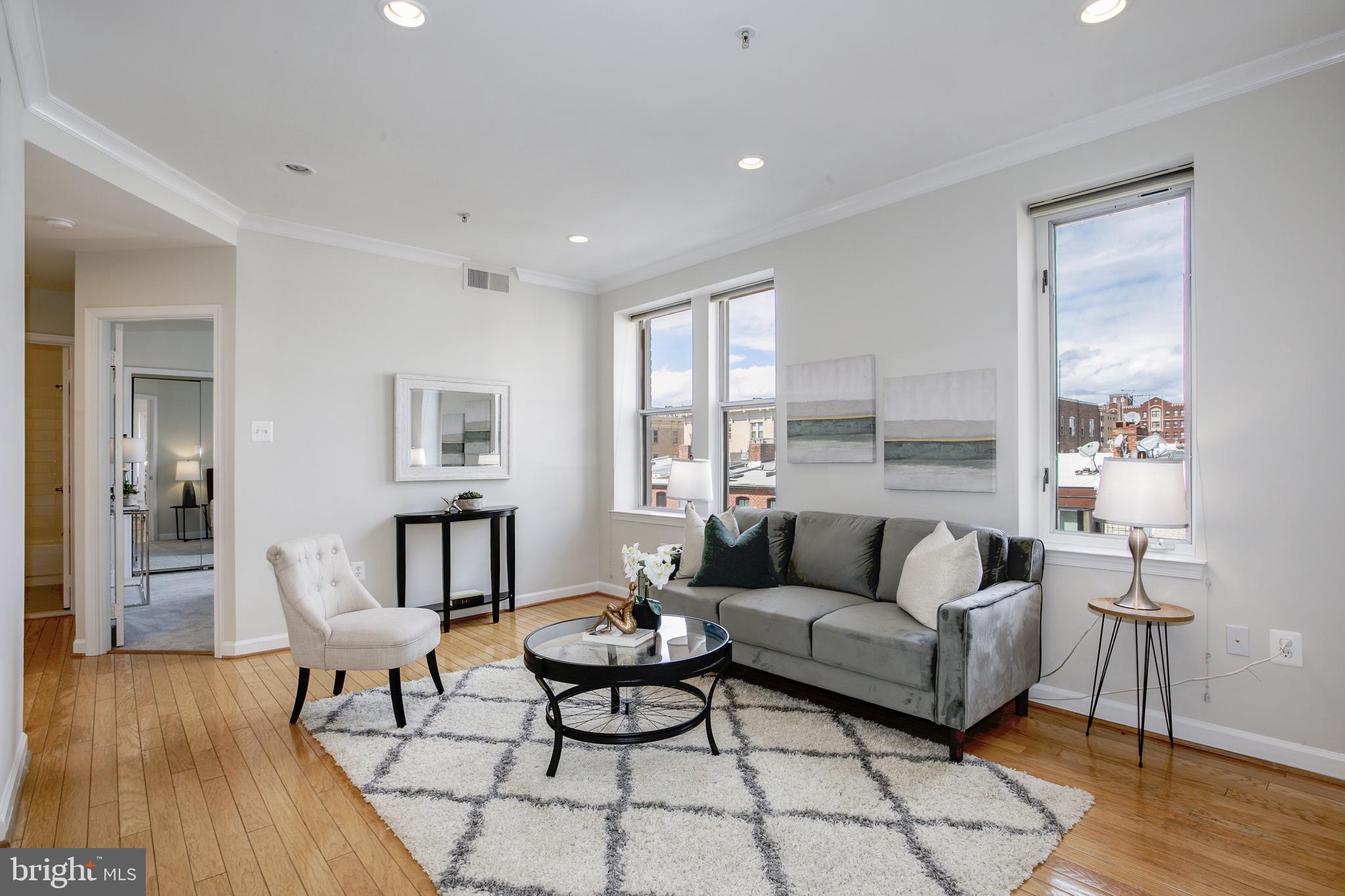 1619 R Street Northwest, Unit 404 Washington, DC 20009 - Photo 3 of 24 a living room with furniture and a wooden floor
