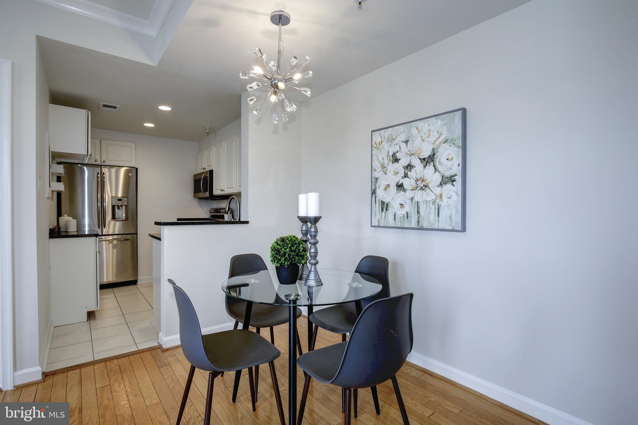 1619 R Street Northwest, Unit 404 Washington, DC 20009 - Photo 5 of 24 a view of a dining room with furniture and wooden floor