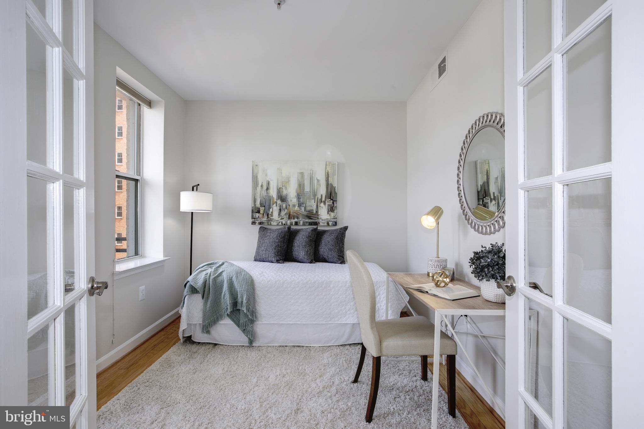 1619 R Street Northwest, Unit 404 Washington, DC 20009 - Photo 9 of 24 a bedroom with a bed and a chandelier