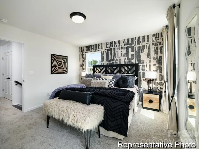 a bedroom with a bed and a night stand