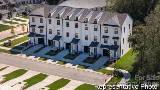 a view of a patio with couches and table potted plants and large tree