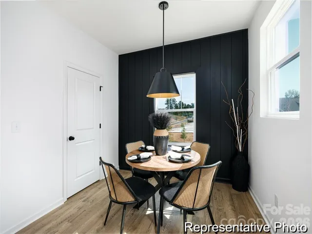 a dining room with furniture and wooden floor