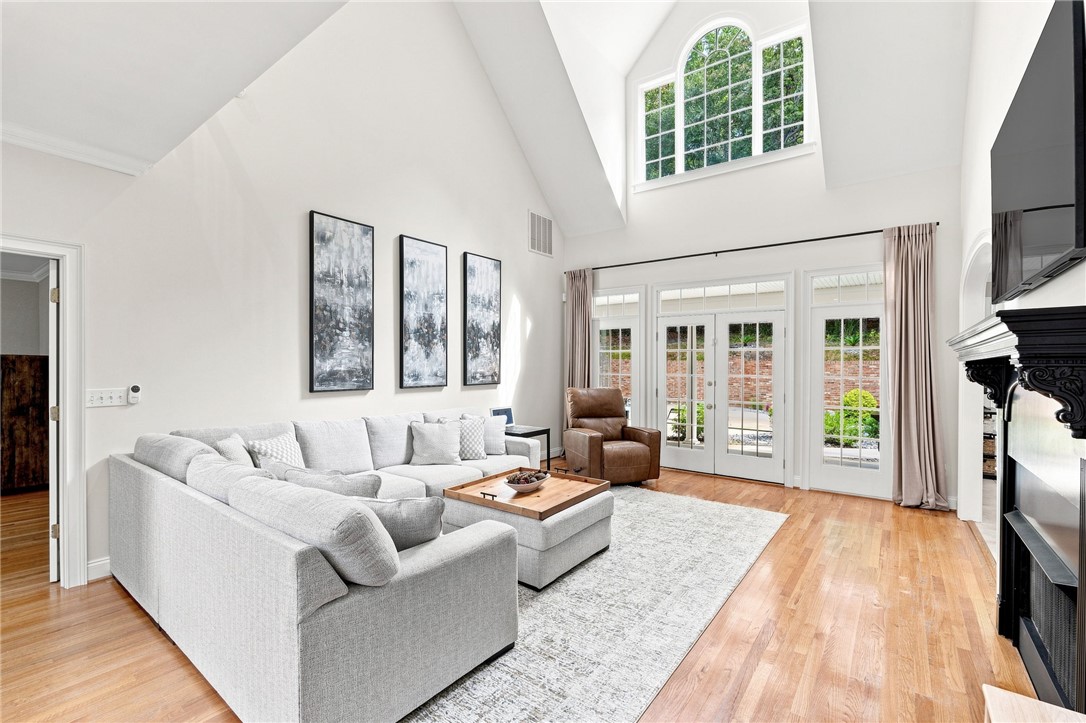 320 Watson Road Easley, SC 29642 - Photo 8 of 50 Soaring vaulted ceilings and polished hardwood flooring elevate this airy, light-filled living room.