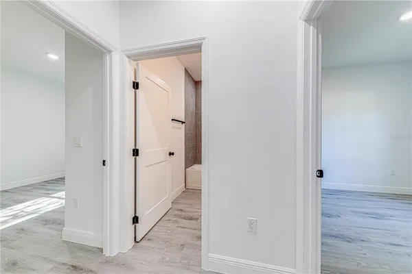 a view of a hallway with wooden floor