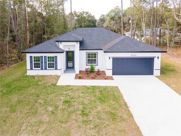 a view of a house with pool and chairs