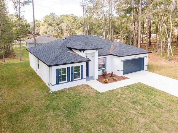 a aerial view of a house with table and chairs