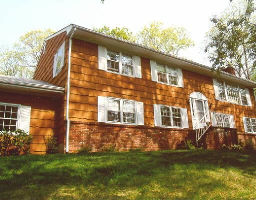 39 Sawmill Road Stamford, CT 06903 - Photo 1 of 1 a front view of a house with a yard