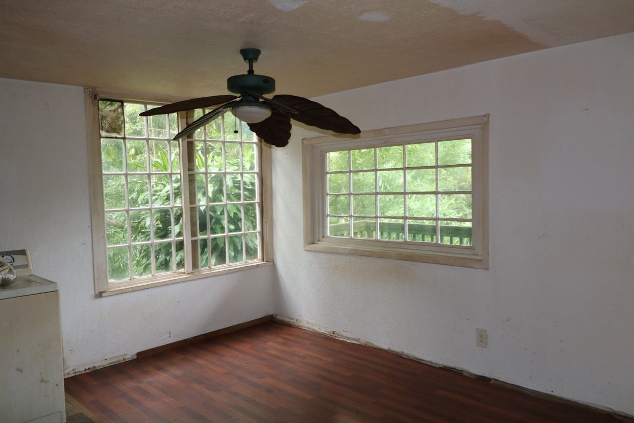 475 B Kulike Road Haiku, HI 96708 - Photo 14 of 17 a view of an empty room with wooden floor and a window