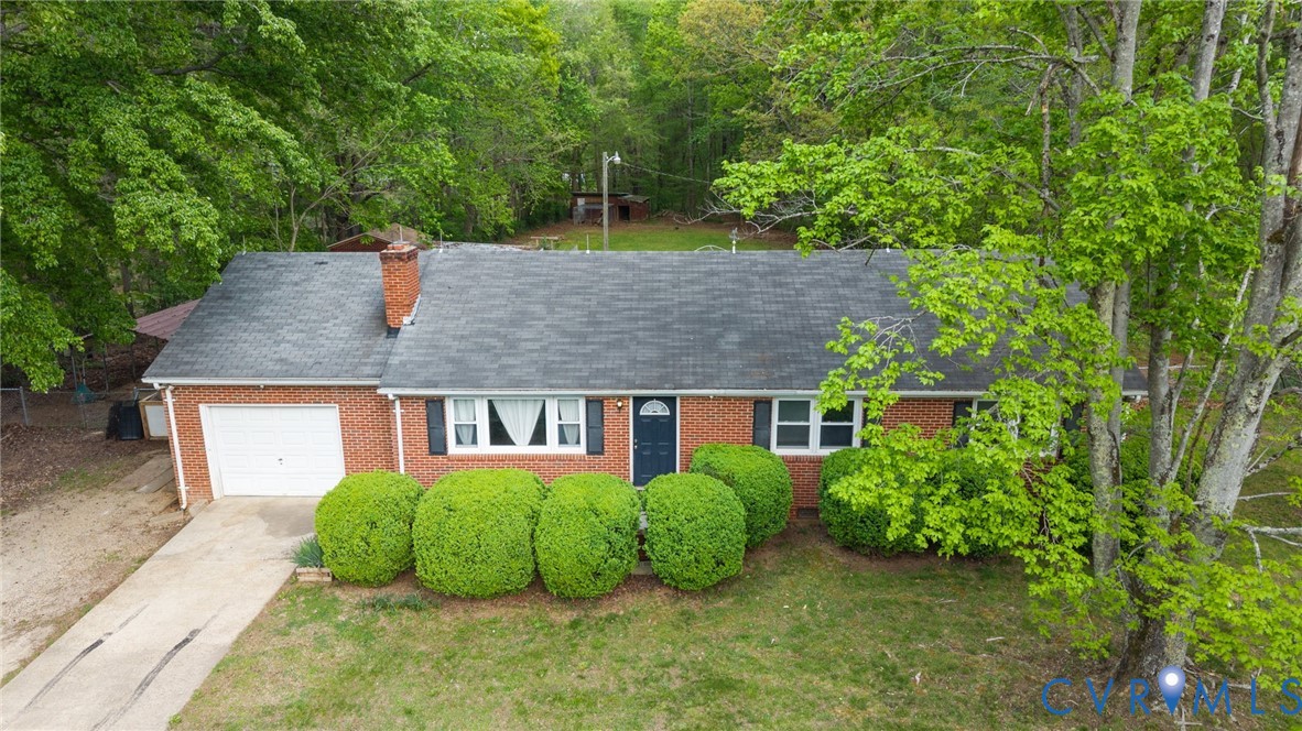 8141 Military Road Amelia Court House, VA 23002 - Photo 3 of 40 a view of a house with garden and plants