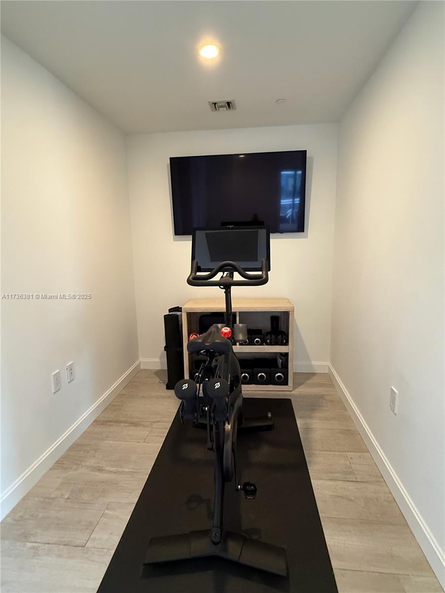 55 Southwest 9th Street, Unit 1701 Miami, FL 33130 - Photo 11 of 58 a room with furniture and wooden floor