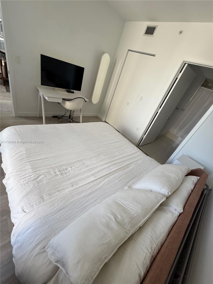 55 Southwest 9th Street, Unit 1701 Miami, FL 33130 - Photo 13 of 58 a large white bed in a white room