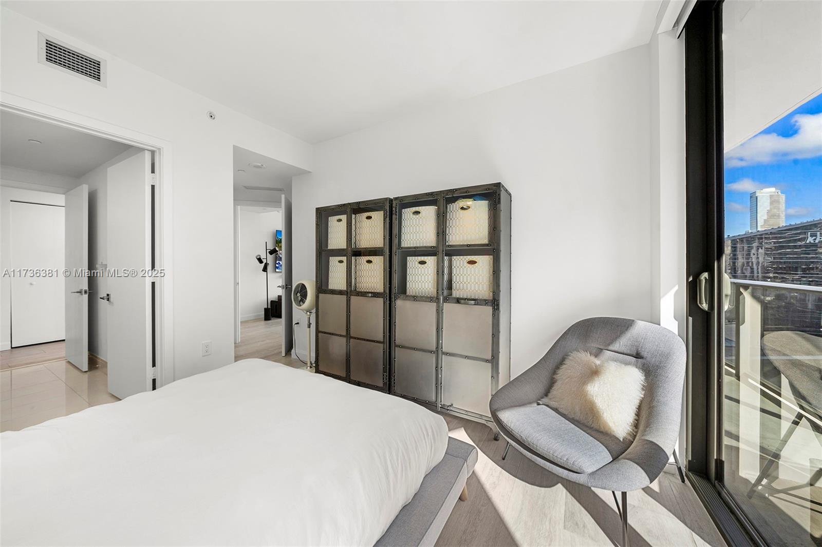 55 Southwest 9th Street, Unit 1701 Miami, FL 33130 - Photo 14 of 58 a bedroom with a bed and a window