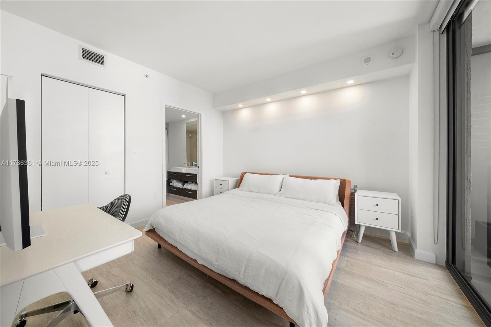 55 Southwest 9th Street, Unit 1701 Miami, FL 33130 - Photo 15 of 58 a bedroom with a bed and a large mirror