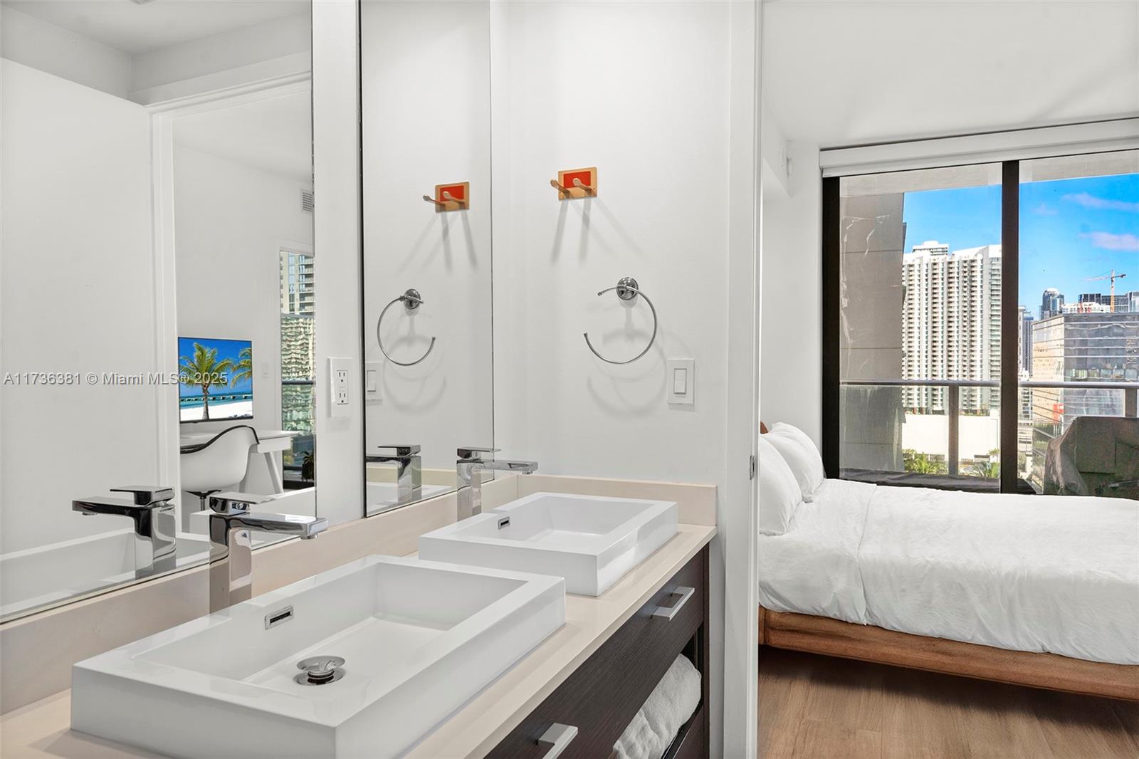 55 Southwest 9th Street, Unit 1701 Miami, FL 33130 - Photo 19 of 58 a bathroom with a sink and a mirror