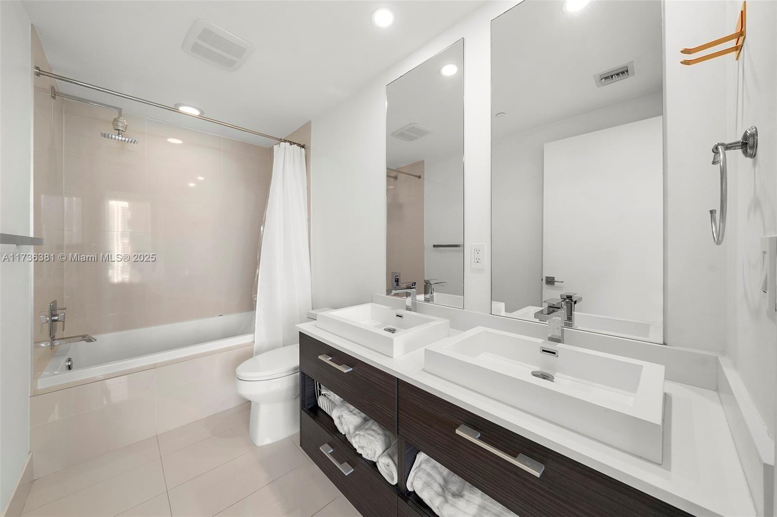 55 Southwest 9th Street, Unit 1701 Miami, FL 33130 - Photo 22 of 58 a bathroom with a bathtub shower sink mirror and toilet