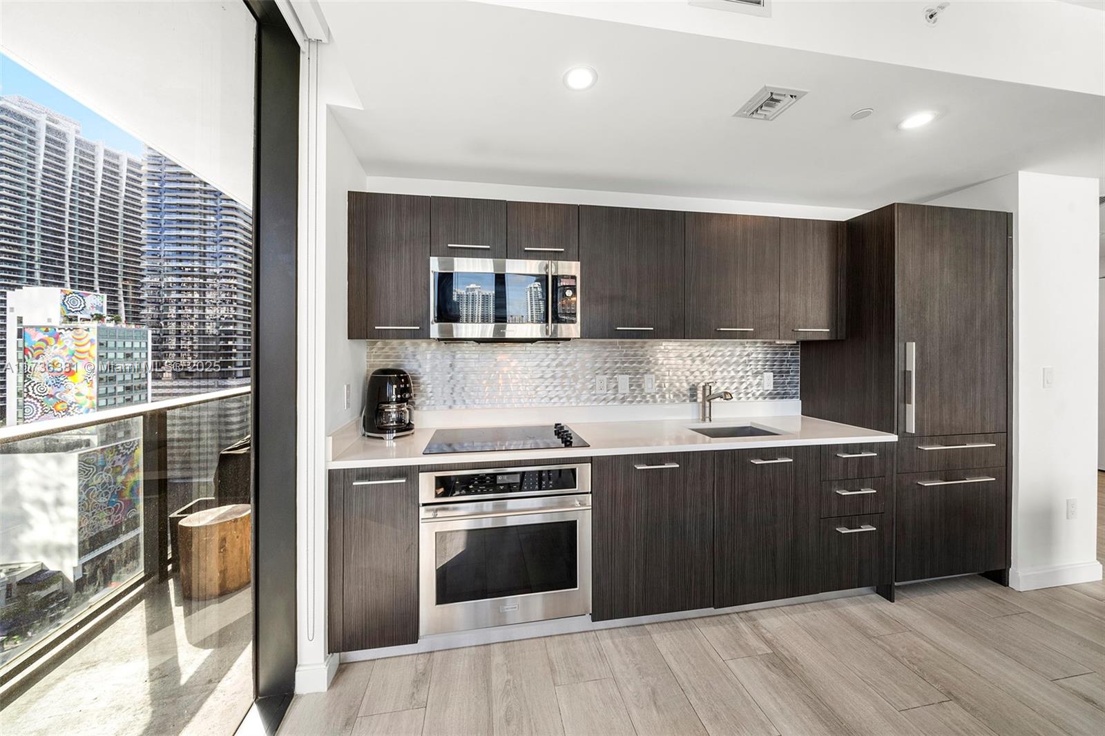 55 Southwest 9th Street, Unit 1701 Miami, FL 33130 - Photo 6 of 58 a kitchen with stainless steel appliances granite countertop a refrigerator and a sink