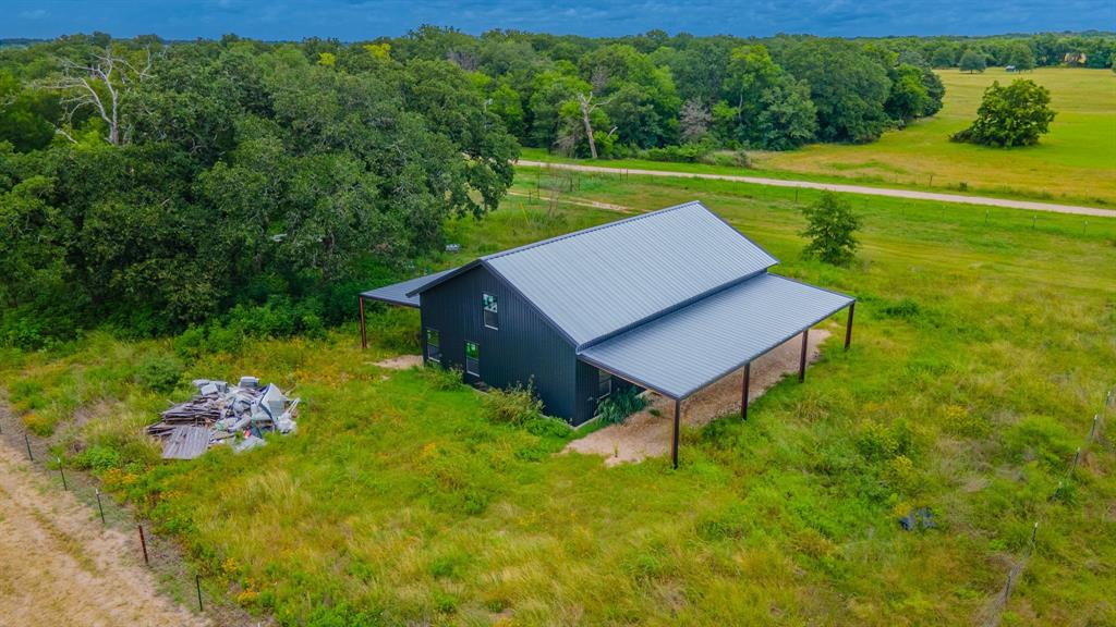 Tbd Wiggins Road West, TX 76691 - Photo 8 of 11 Barn-style residence featuring a dark facade and a gray metal roof