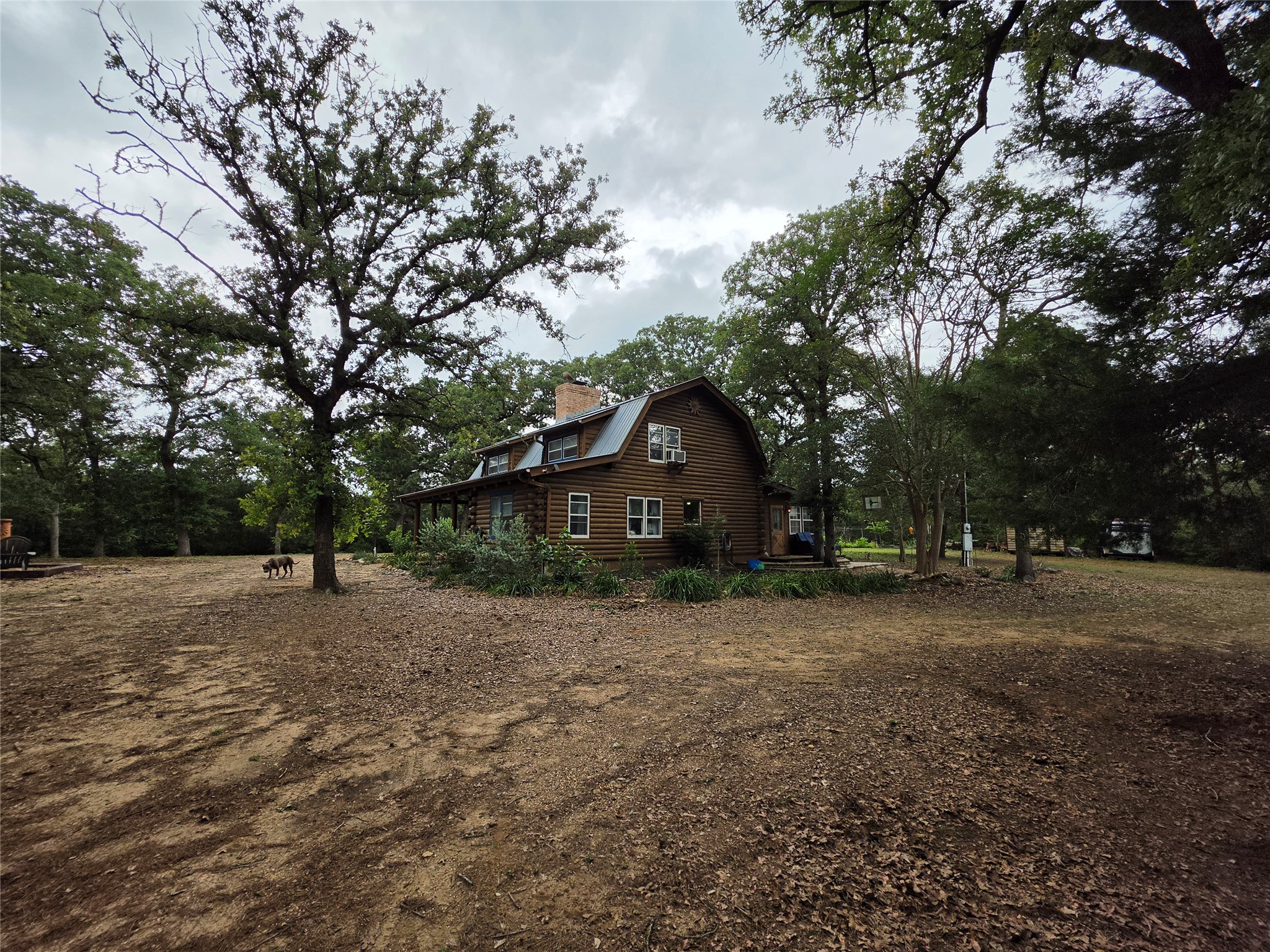 1053 East County Rd F Lexington, TX 78947 - Photo 36 of 38 a front view of a house with a yard and tree s