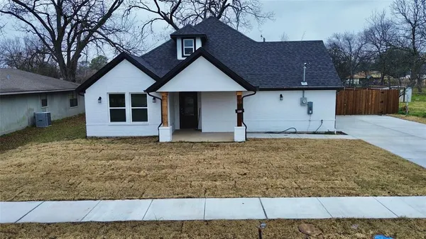 a house that has a tree in front of it