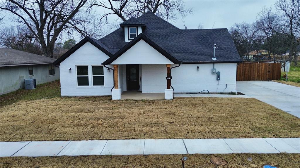 a house that has a tree in front of it