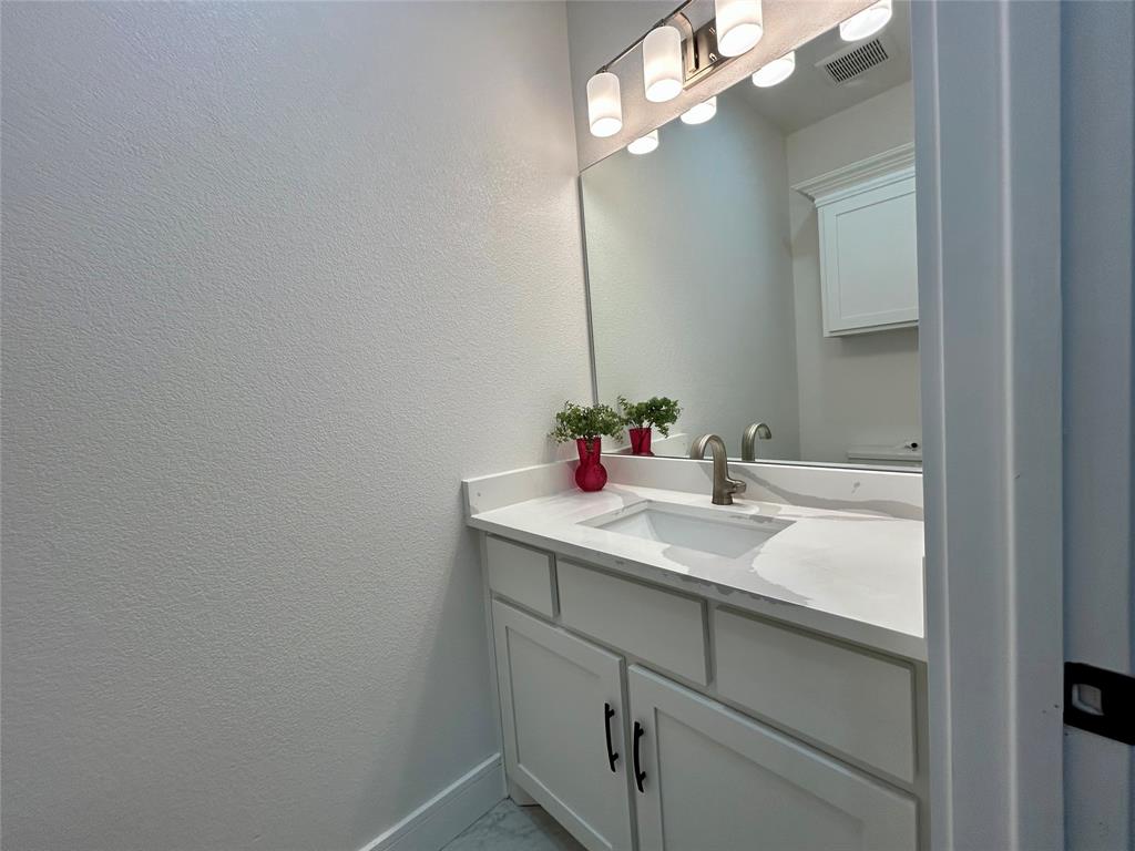 802 South Medora Street Terrell, TX 75160 - Photo 11 of 34 a bathroom with a sink vanity and mirror