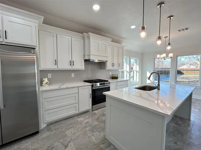 a kitchen with a sink stainless steel appliances and cabinets