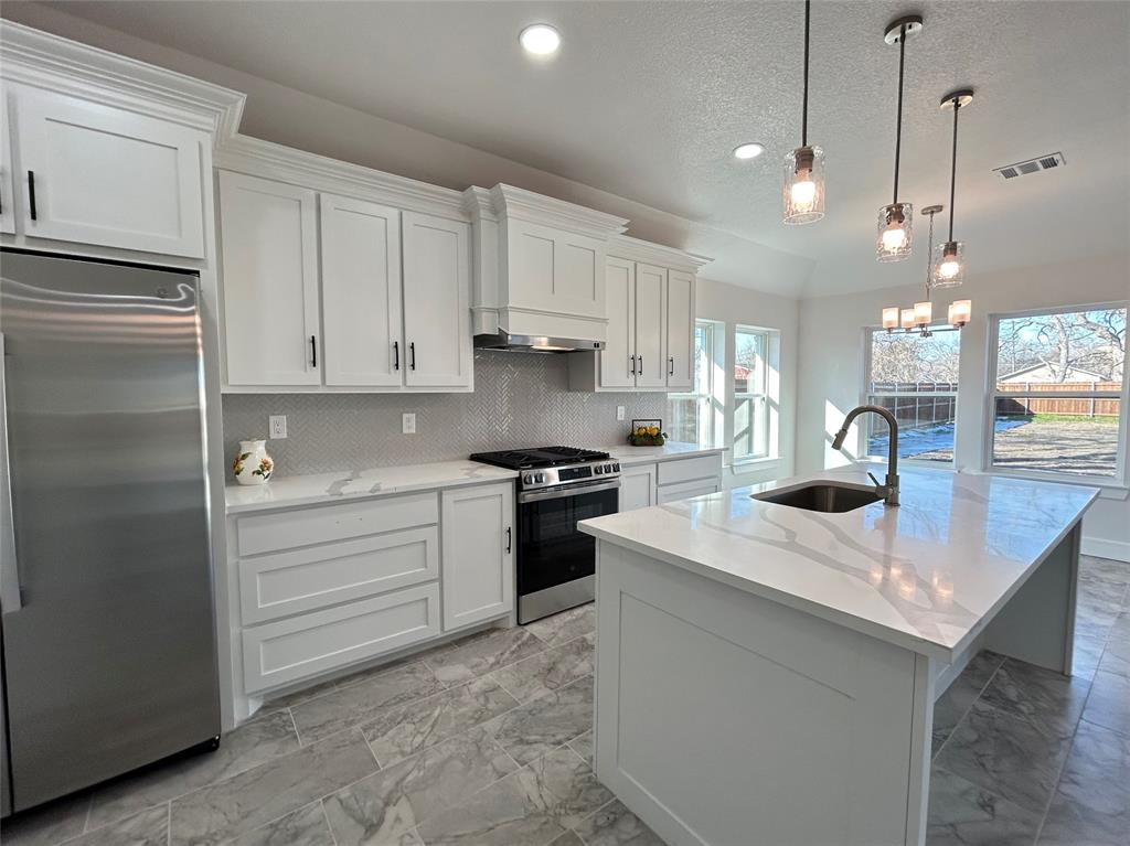 802 South Medora Street Terrell, TX 75160 - Photo 15 of 34 a kitchen with a sink stainless steel appliances and cabinets